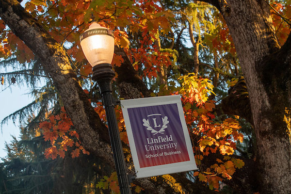 a light post with a ѨƵ School of Business banner on the McMinnville campus in the fall